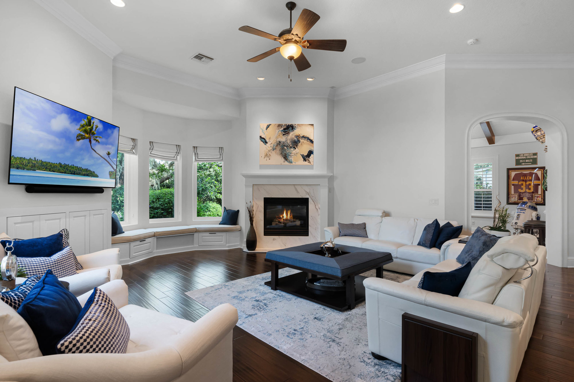 living room with white and beige furniture and blue accents